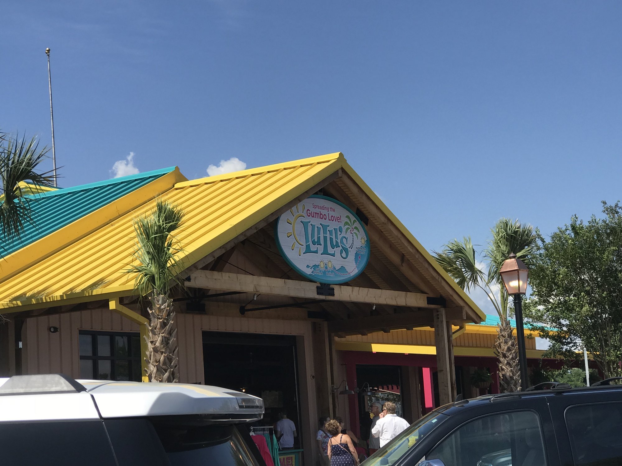 LuLu's restaurant exterior with yellow roof and palm trees at Barefoot Landing North Myrtle Beach