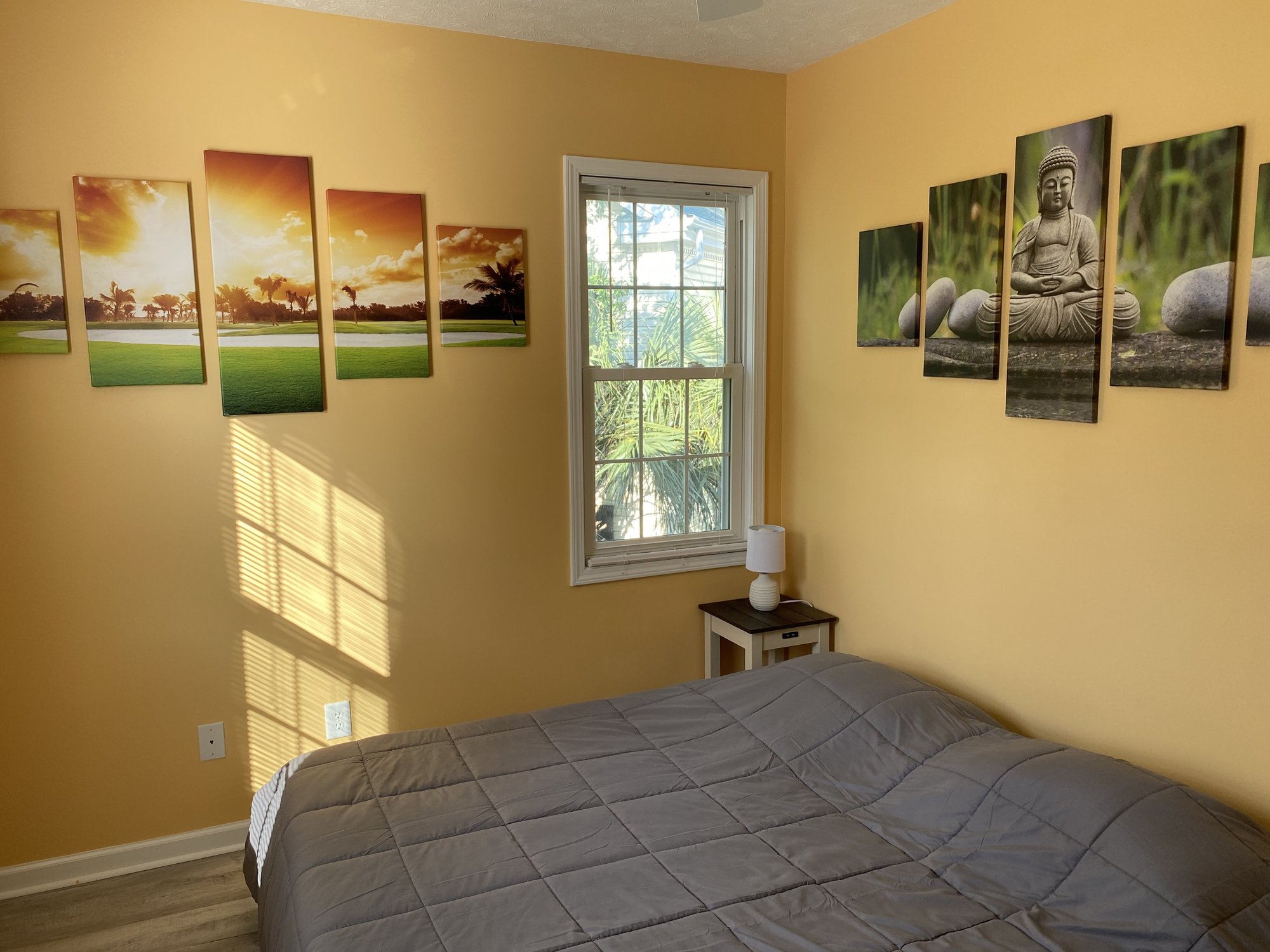 Sun-themed third bedroom with sunset and zen wall art at 601 Hillside Dr N
