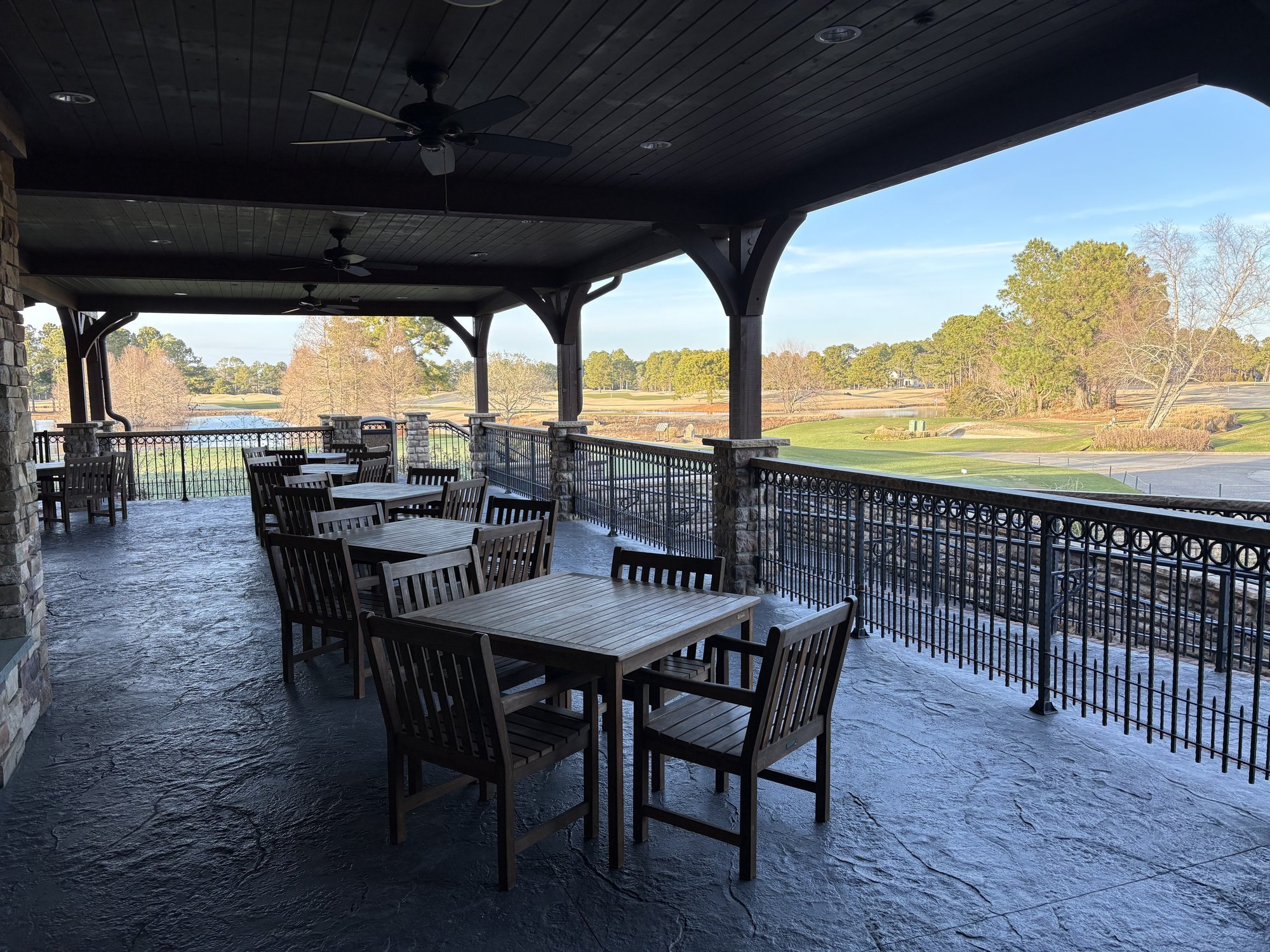 Covered patio with wrought iron railing and golf course views at Thistle Golf Club Sunset Beach NC