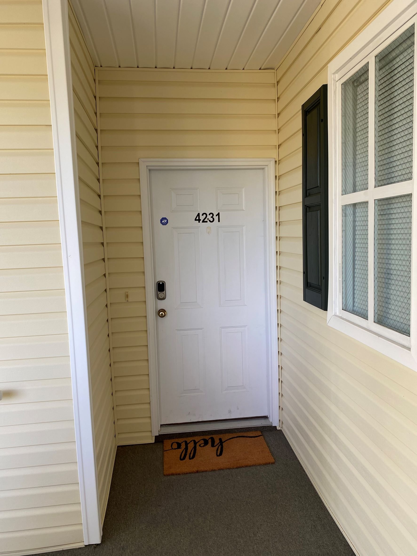 Front door of unit 4231 at 601 Hillside Dr N with hello doormat