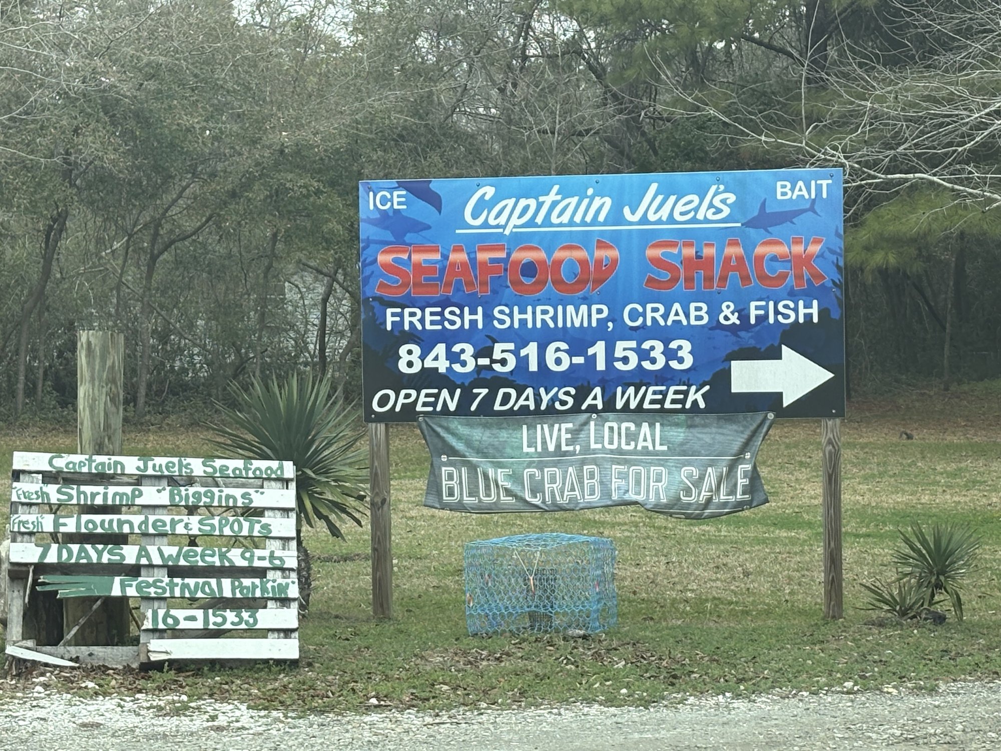 Captain Juel's Seafood Shack sign with crab trap in Little River SC