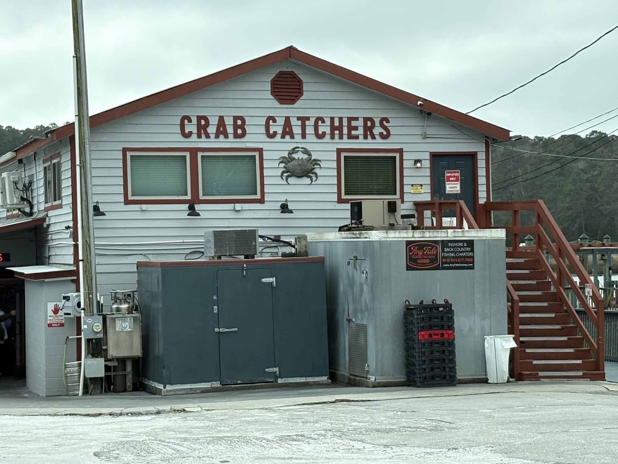 Crab Catchers restaurant building with metal crab on the Little River waterfront SC