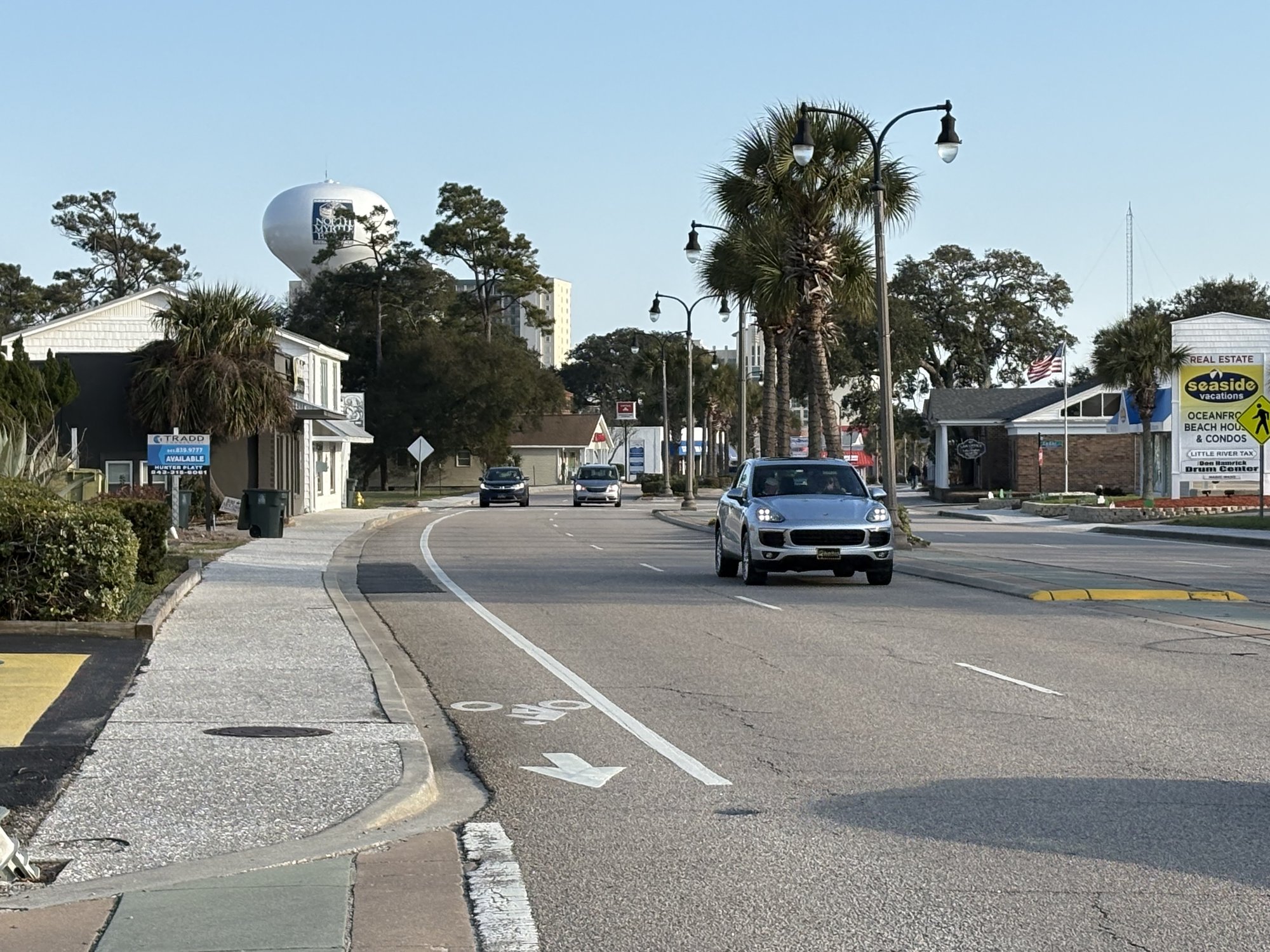 Main Street North Myrtle Beach corridor with water tower palm trees and street lamps