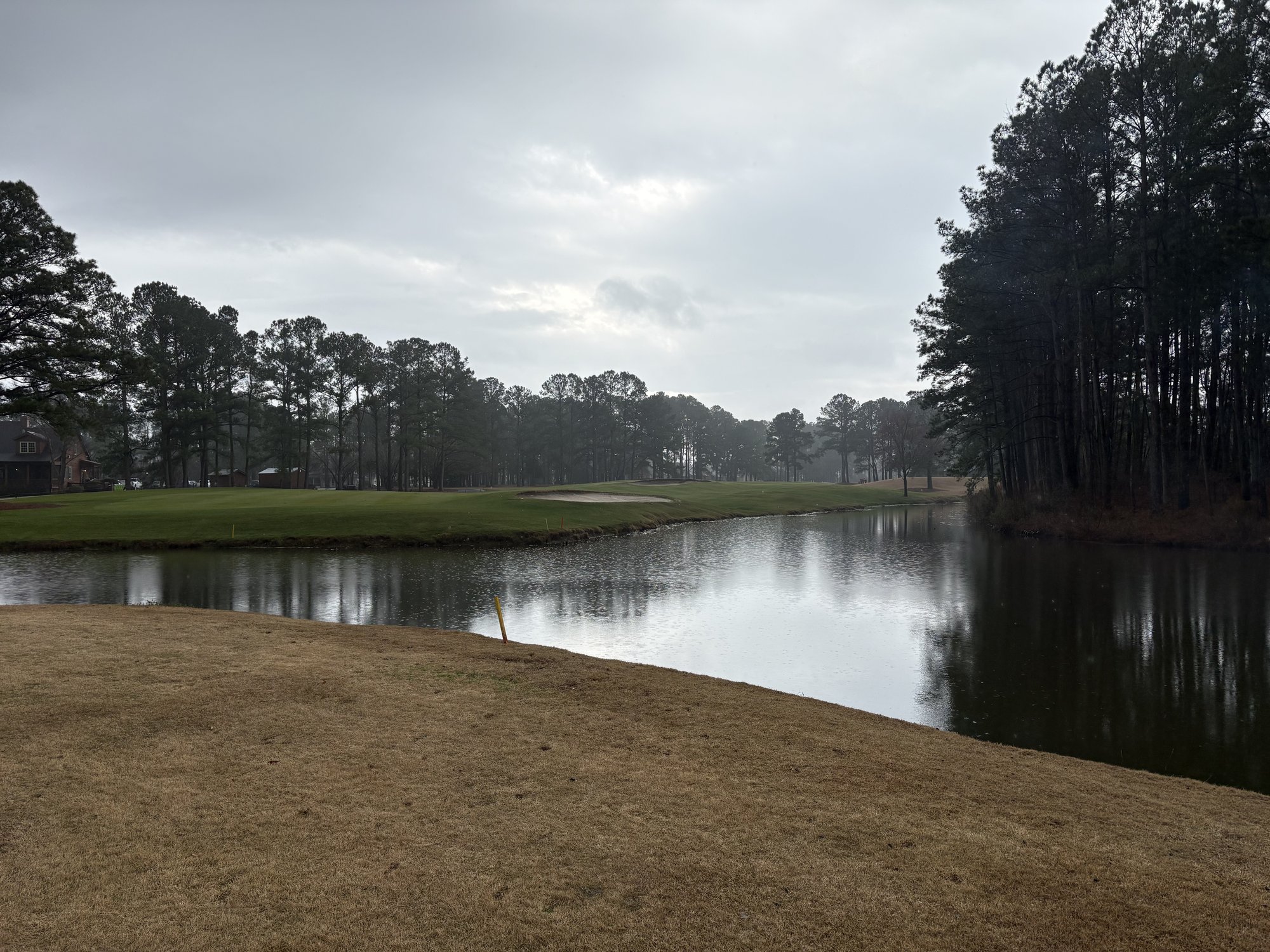 Water hazard with pine tree reflections at Meadowlands Golf Club Calabash NC