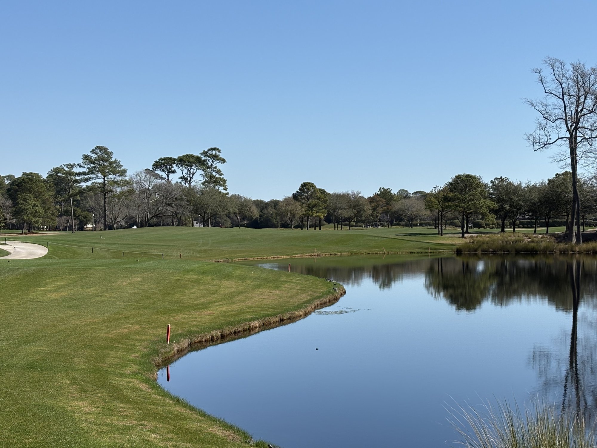 Fairway along lake with mirror reflections at Pine Lakes Country Club Myrtle Beach SC