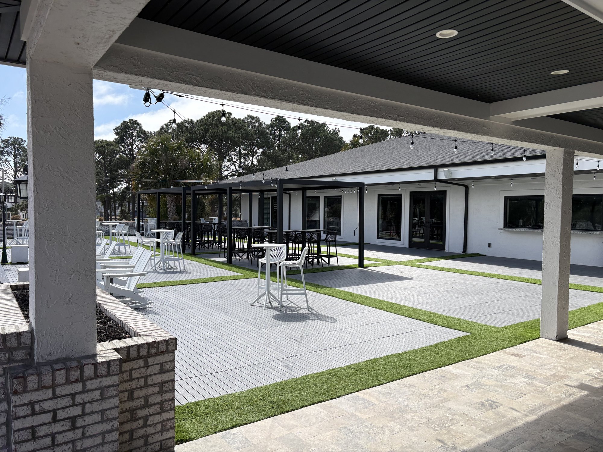 Modern outdoor patio with string lights and furniture at Sea Trail Golf Resort Sunset Beach NC